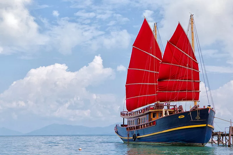 samui's infamous red sailed traditional sailing junk yacht the red baron