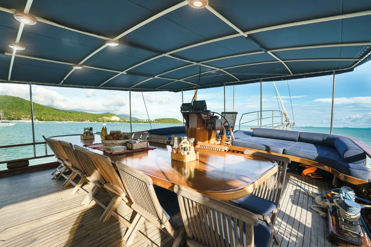 lounge set for gourmet dining on the naga traditional yacht, samui