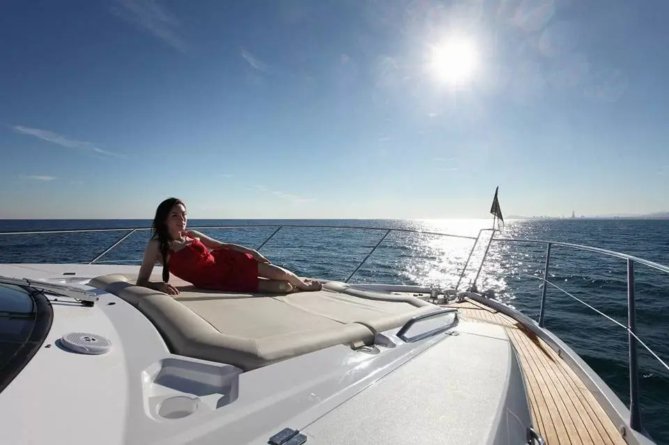 image shows woman sunbathing on our sunseeker manhattan luxury motor yacht near koh phangan